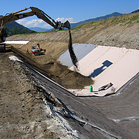 Rainwater retention basin with concrete mat cover on the bank sides to prevent erosion