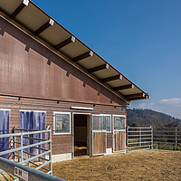 Brown windbreak net on stable building