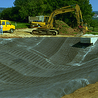 Workers in the process of laying NaBento geosynthetic clay liner for optimal waterproofing and sealing function.