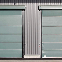 Large folding front next to two green, closed Stabitors at a fertilizer warehouse