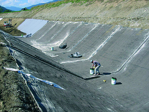 Waterproofing work carried out by workers on the headrace at the power station
