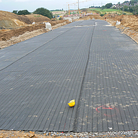 Earthfall bridging with geogrids