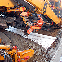 Machine lifts rails and lays Basetrac® Duo geocomposite