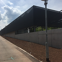 Black, textile facade cladding at the recycling centre of the University of Tübingen