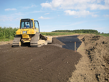 Basetrac Grid is covered with soil by a caterpillar