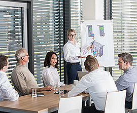 Employees in a meeting room of the HUESKER Group