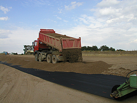 Earth is tipped onto Fortrac A geogrid rollers, consisting of high-strength aramid, ideal for earthfall bridging