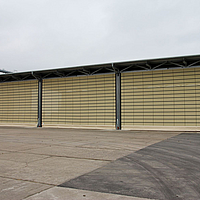 Beige Lubratec folding fronts as doors for the grain store