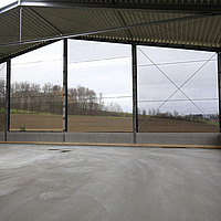 Interior view of windbreak nets covering the front of a warehouse.