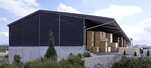 Tectura façade cladding Warehouse with textile façade. In the background a lake with a planted bank