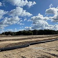 Basetrac Grid geogrid on roll, waiting to be laid on the construction site